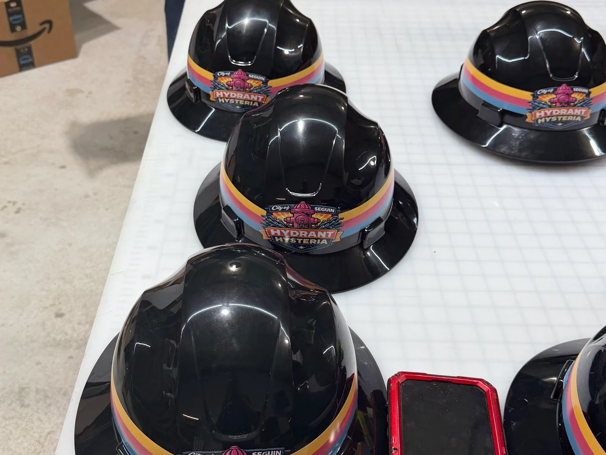 Branded hard hats with rainbow striped logos